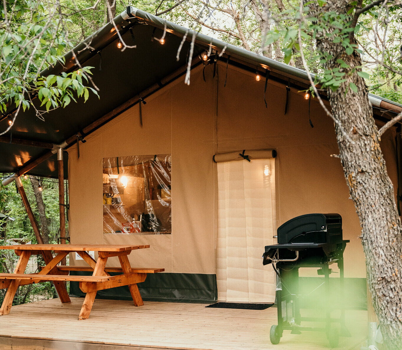 Glamping cabin in the woods with picnic table outside for a glamping experience