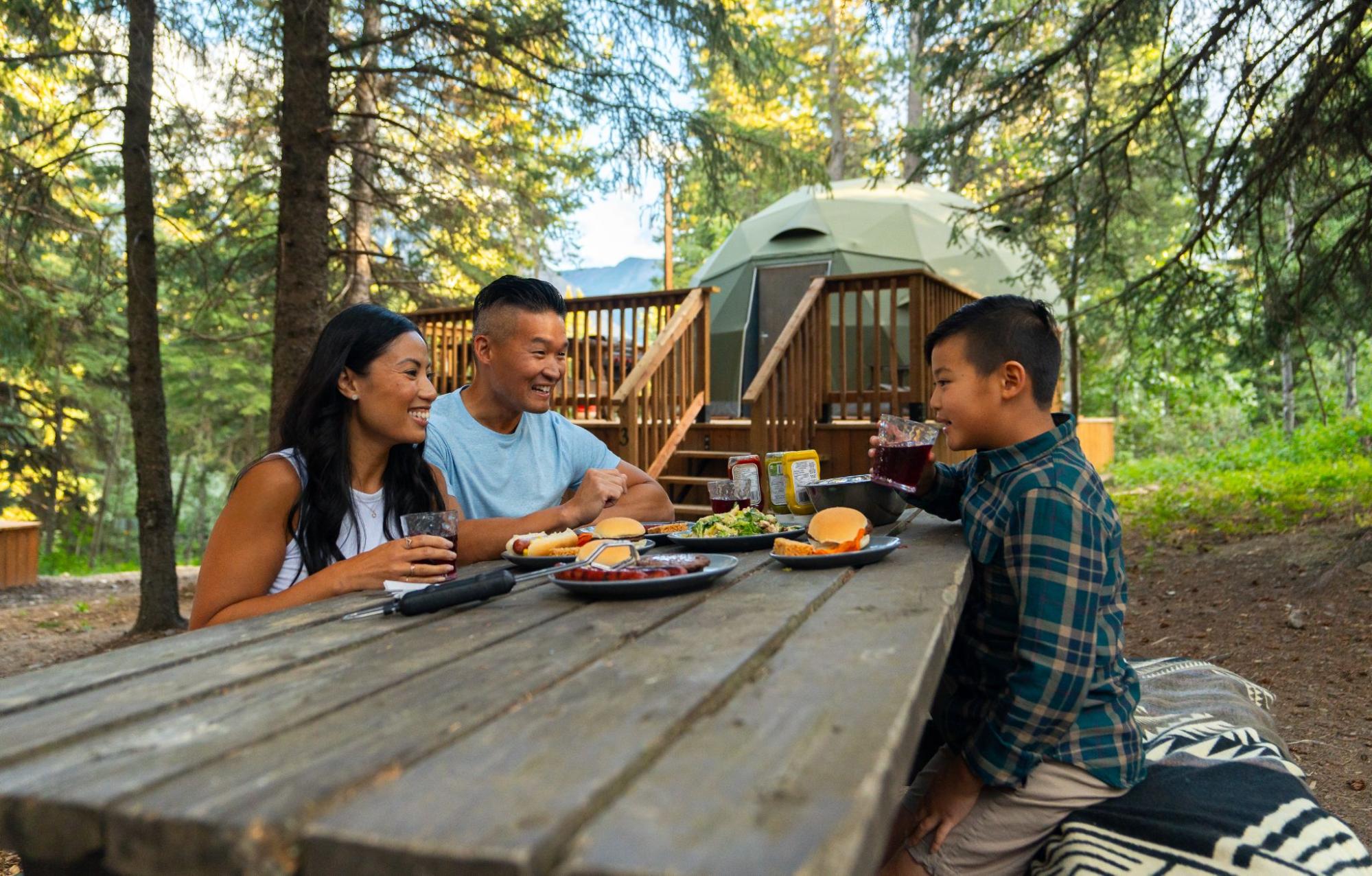 A family enjoying quality time together at a glamping resort.